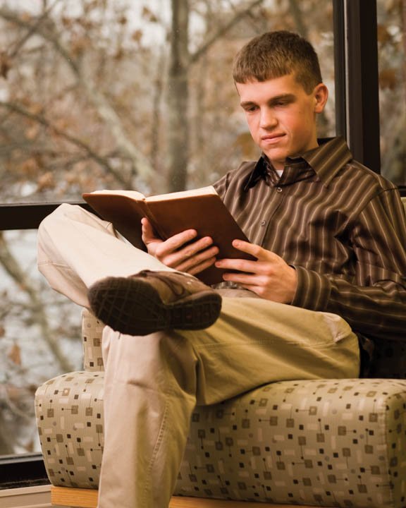 Mormon young amn reading scriptures